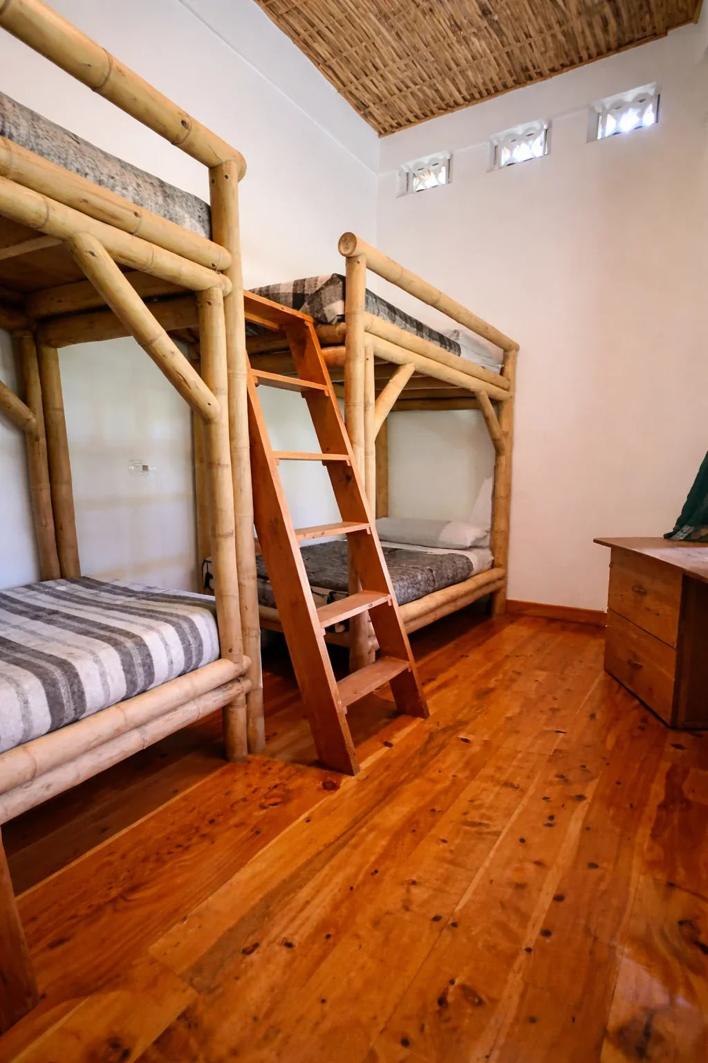 Bright shared room with bamboo bunk beds at Maestro Valley