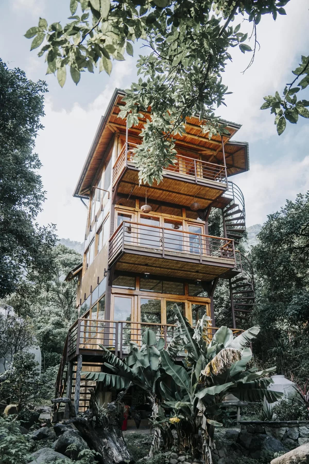Multi-level retreat tower rising through the Maestro Valley forest