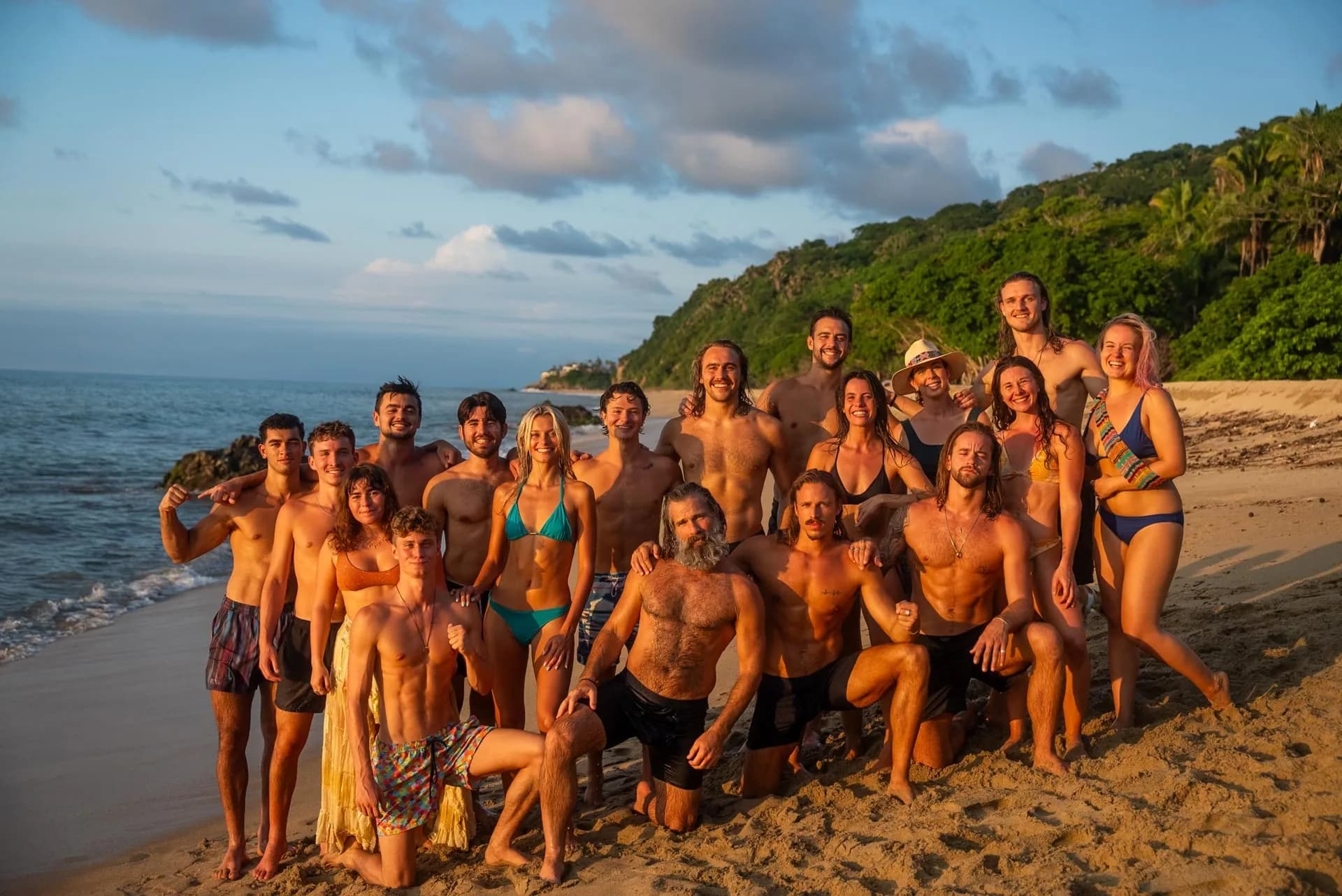 Large Bioculture retreat group gathered together on a beach