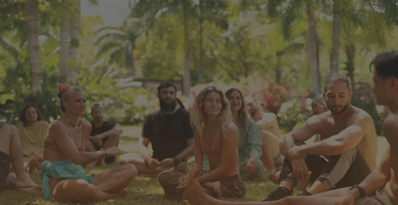Bioculture retreat guests gathered in a circle among trees