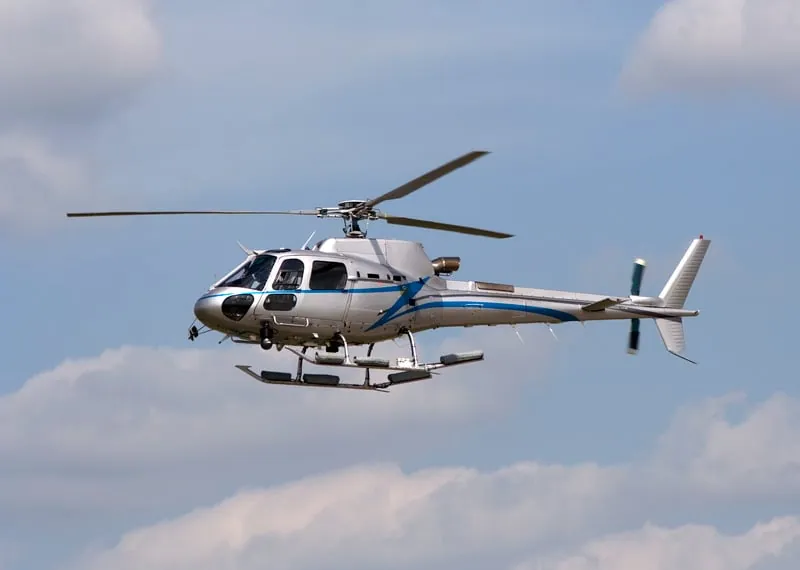 A helicopter flying against a blue sky