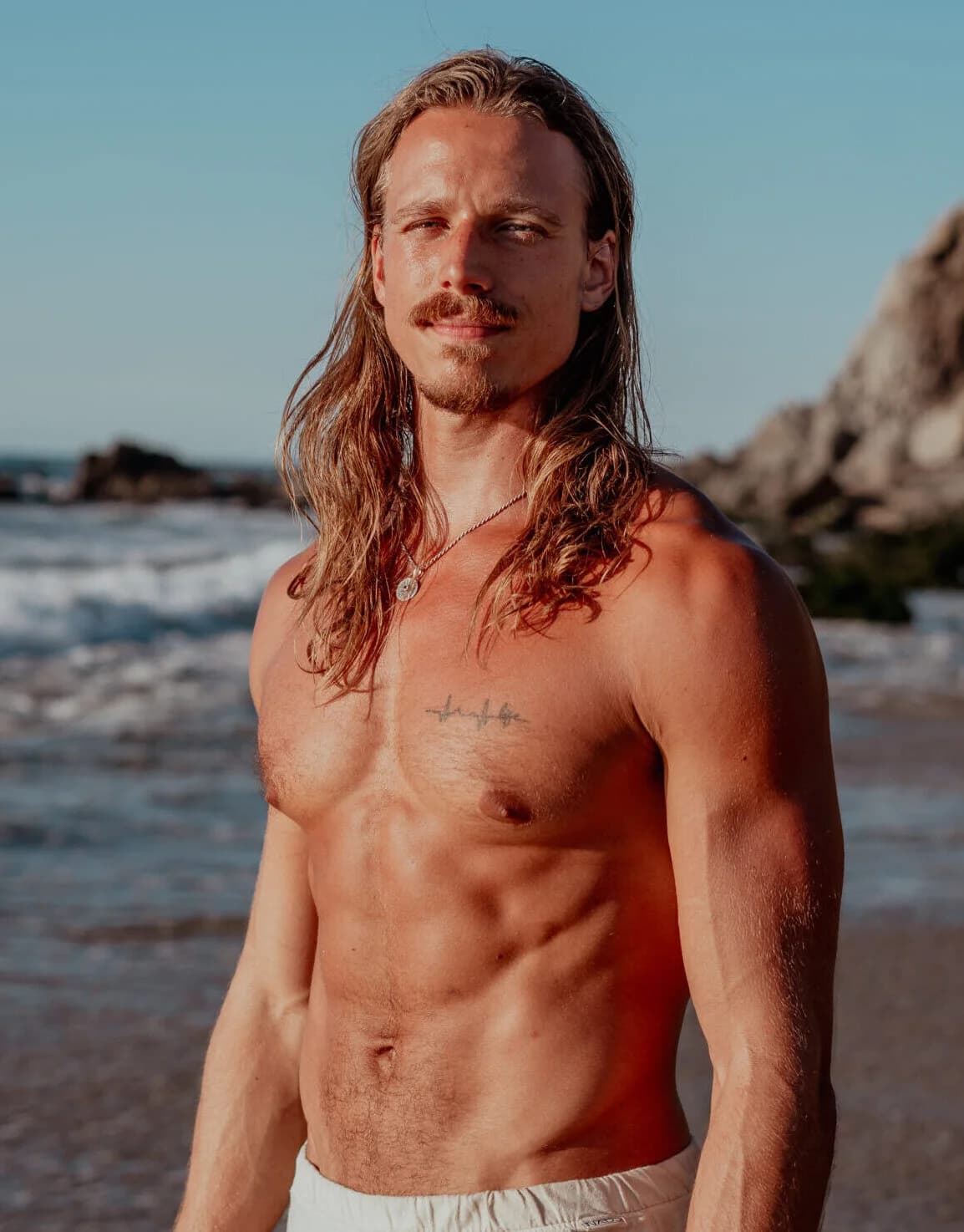Christian Van Camp standing on a rocky shore