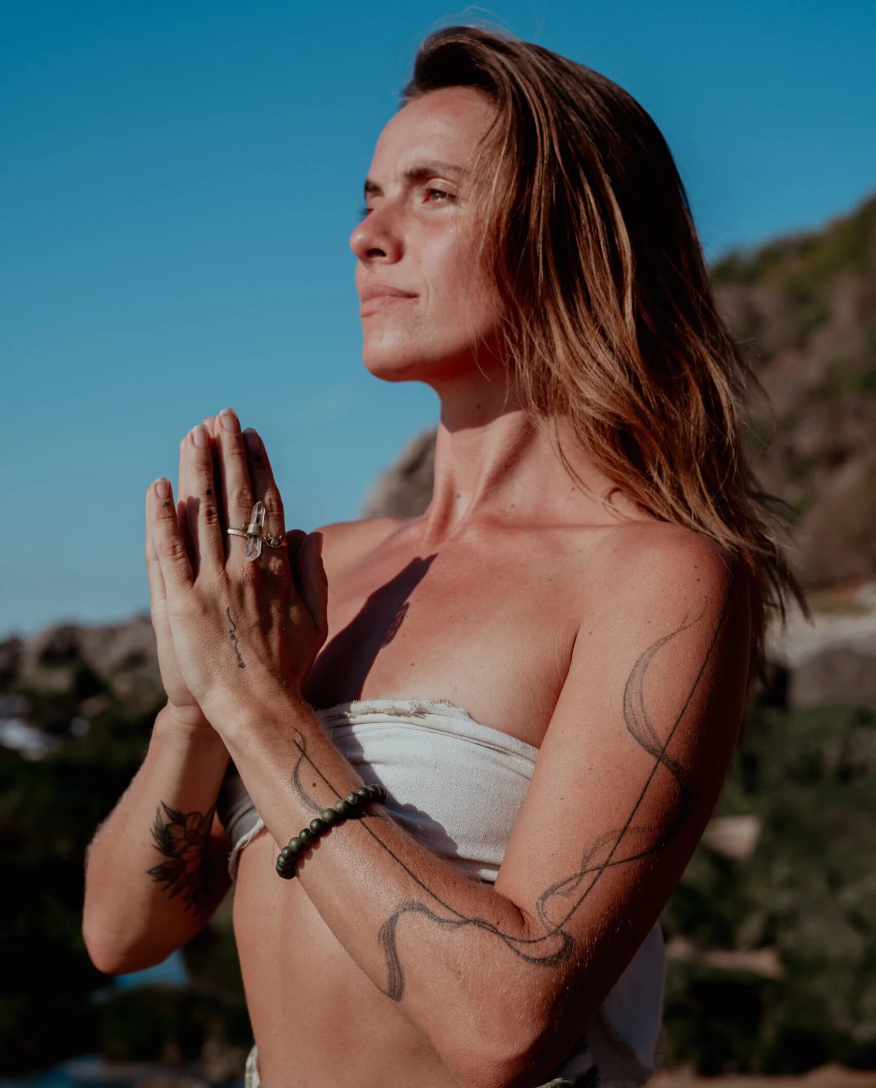 Sedona Holzinger seated outdoors with her hands together