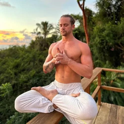 Dakota Mays seated outdoors in a meditation posture