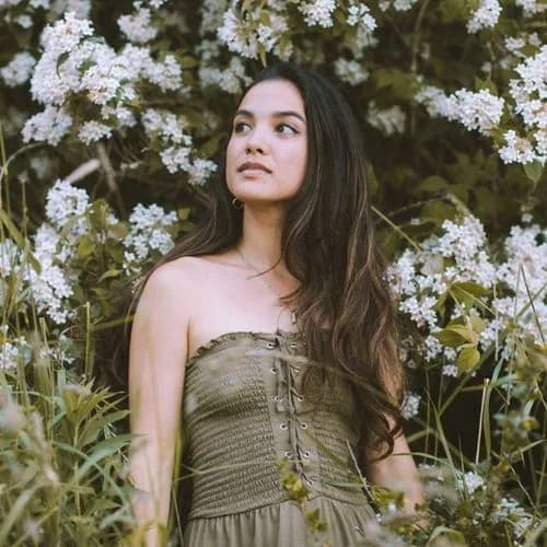 Lisa Power standing among flowering plants