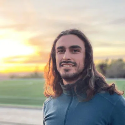 Rad Detchev smiling outdoors at sunset
