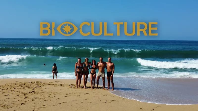 Bioculture guests standing together on a beach beneath the Bioculture wordmark