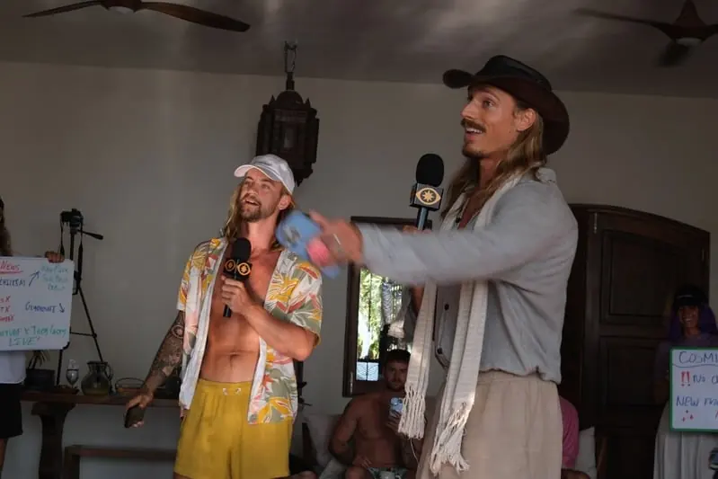 Two hosts speaking into microphones during a live session
