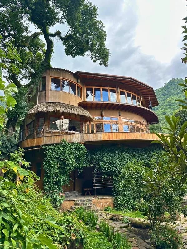 The multi-level wooden main house at Maestro Valley surrounded by jungle