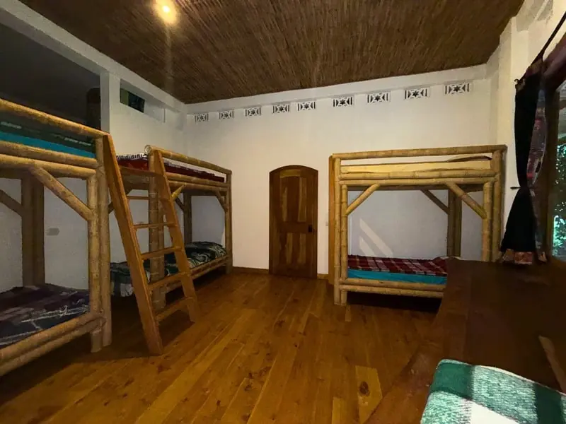 Shared bunk room with wooden bunk beds and a polished floor