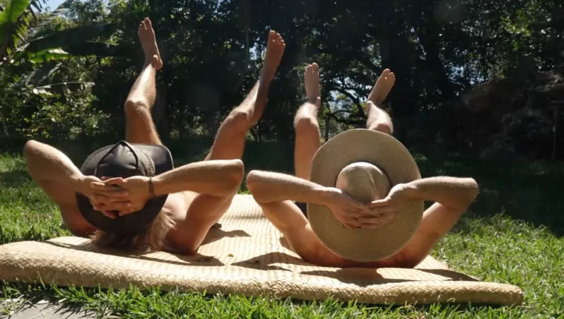 Two guests sunbathing on the grass