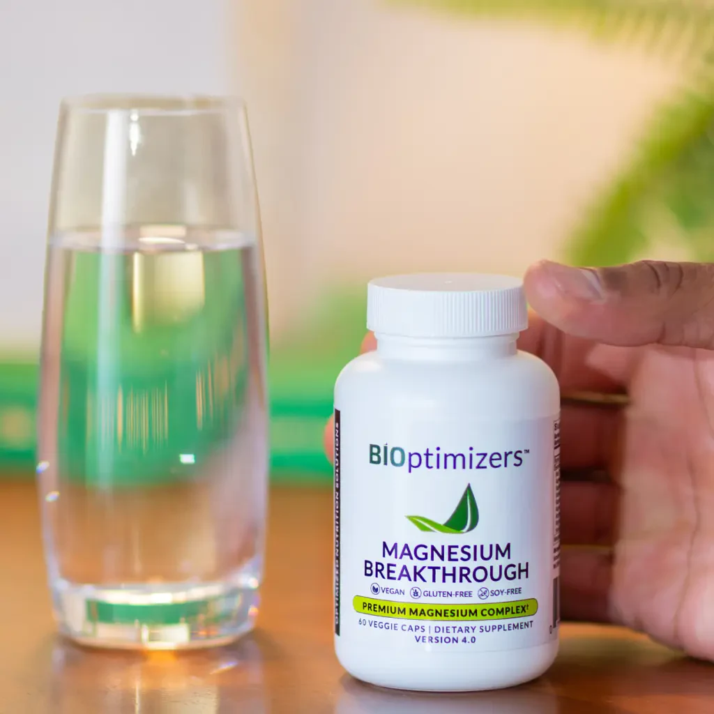 BiOptimizers supplement bottle beside a green drink