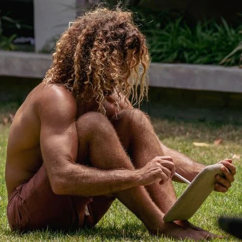 A person using a Daylight Computer tablet outdoors in sunlight