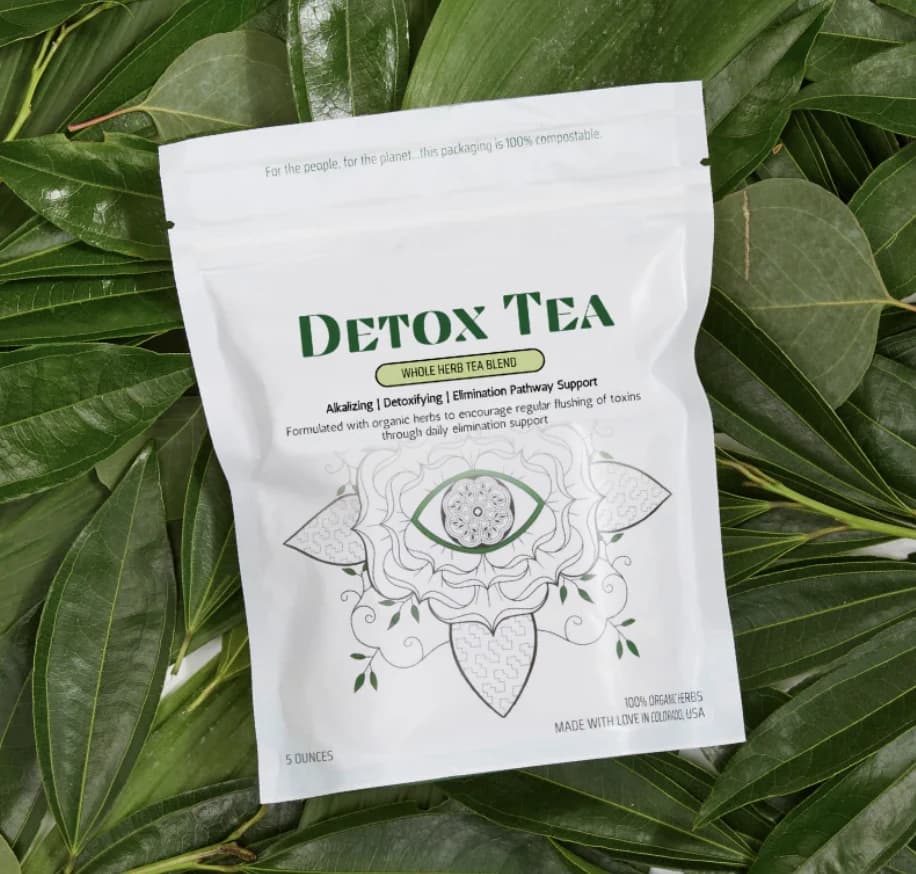 Earth Mother Medicinals detox tea package among green leaves