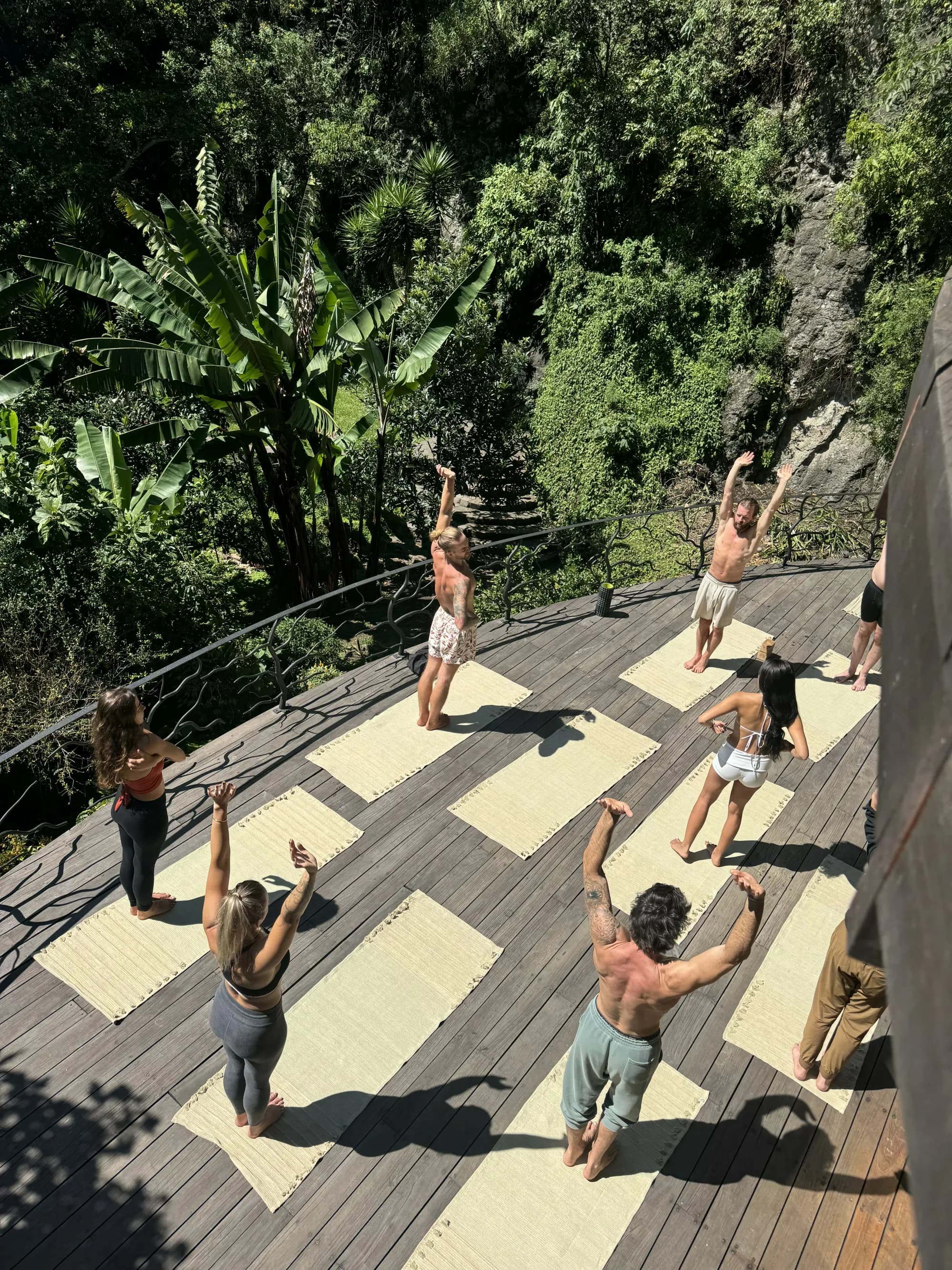 A guided morning movement class on the circular wooden deck above the Maestro Valley jungle canyon
