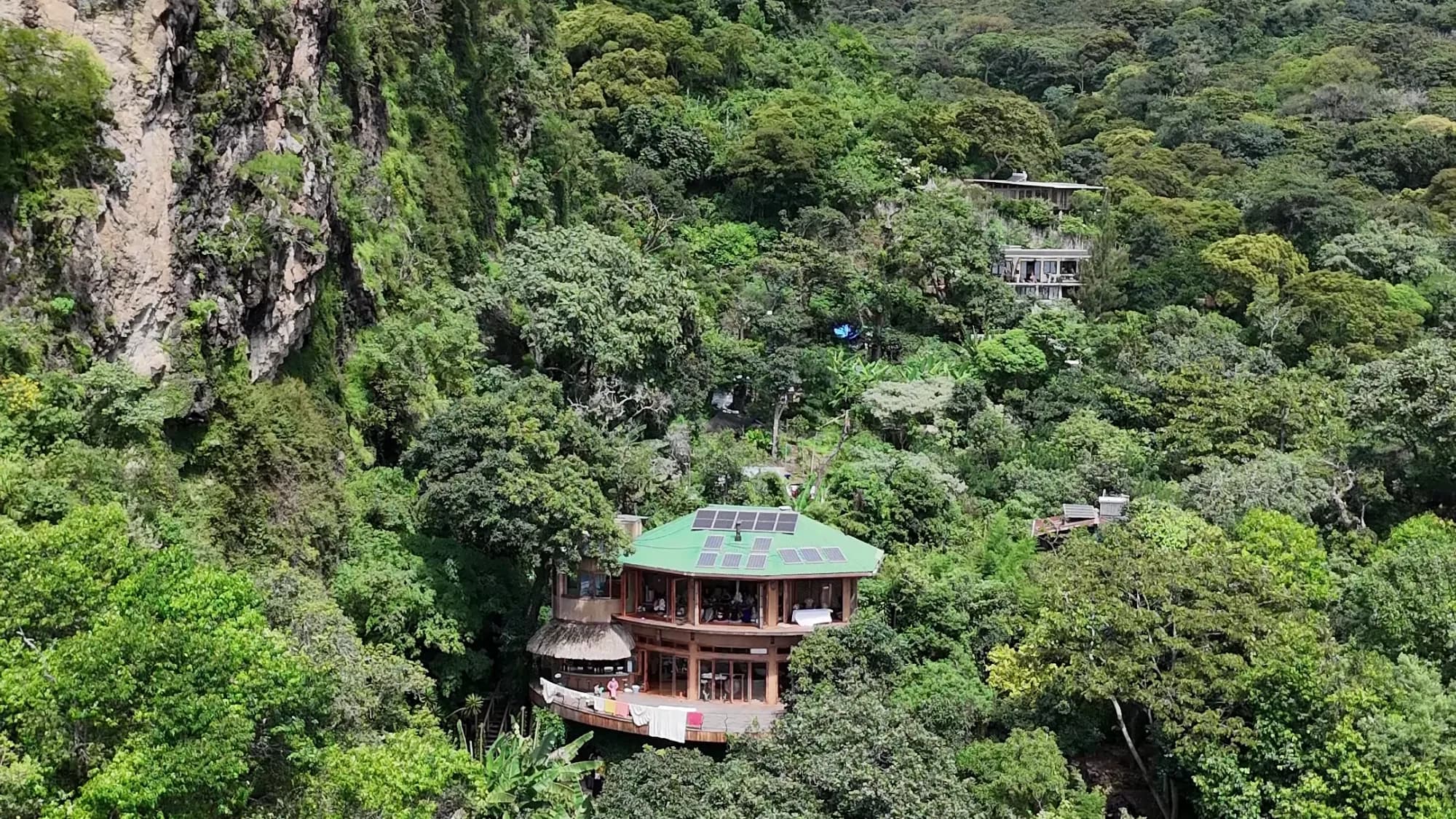 Maestro Valley sanctuary buildings surrounded by dense forest